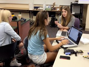 Castle View adviser Jessica Hunzicker works with two editors on plans to make the CV website mesh with the print publications.