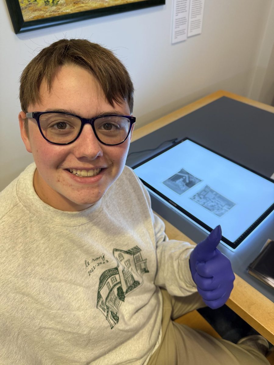 Greer Scholarship winner senior Peter Philpott of Cherry Creek High School's Union Street Journal, pictured at Denver Public Library, examines archival negatives from the 1940s for a historical feature article.